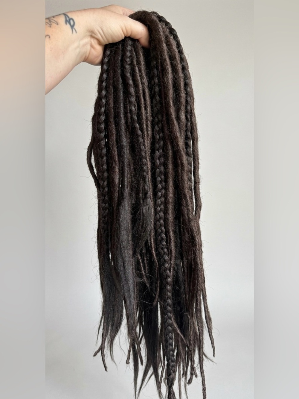Dark brown DE dreadlock extensions.